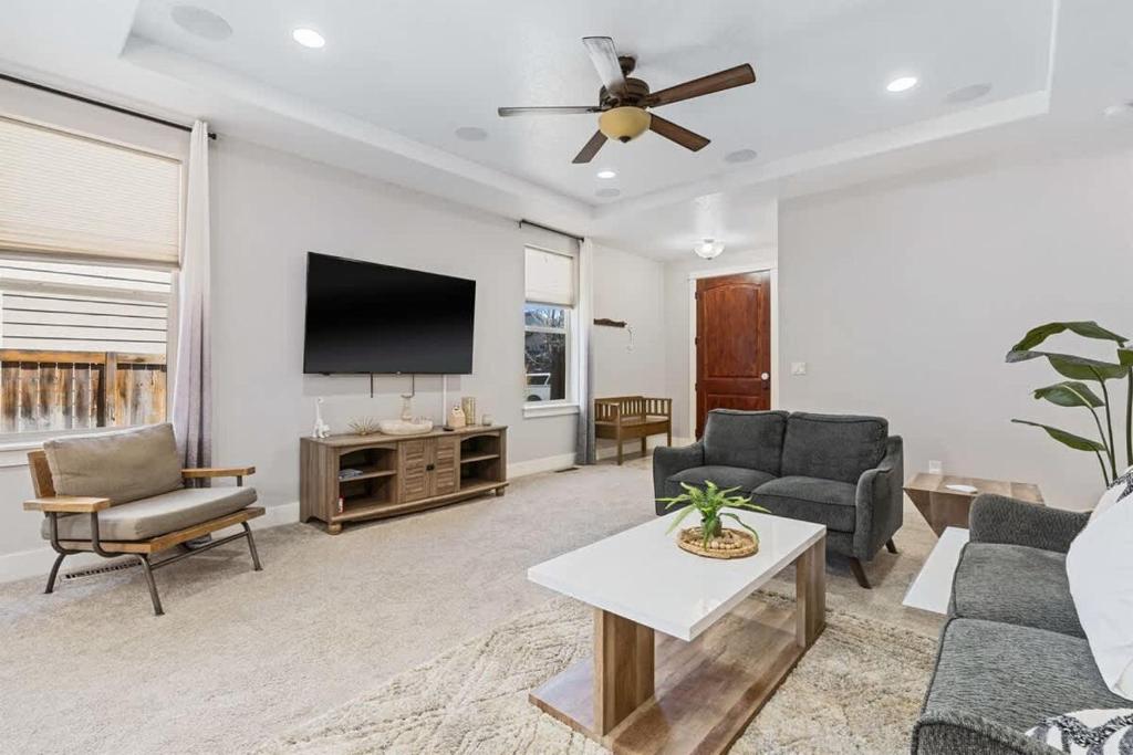 a living room with a couch and a flat screen tv at Sensible Safari Sleeps 10 in Meridian