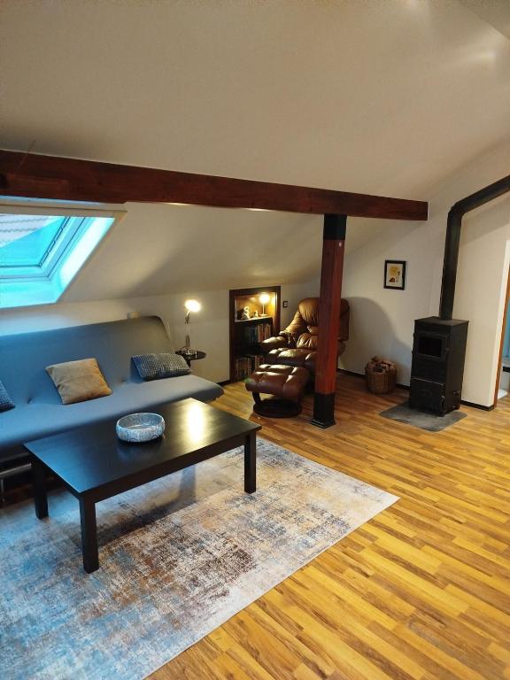 a living room with a blue couch and a table at Altstadt Appartement Luka in Roding