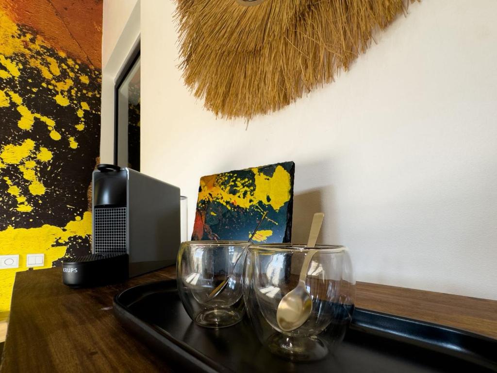 a table with a tray with glasses on it at Club Ébène Ouidah in Ouidah