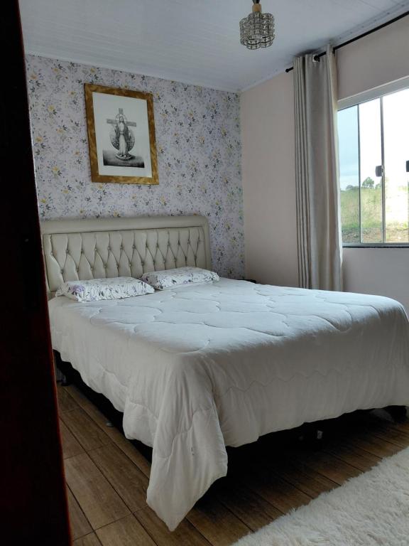 En eller flere senge i et værelse på Recanto do Cedro