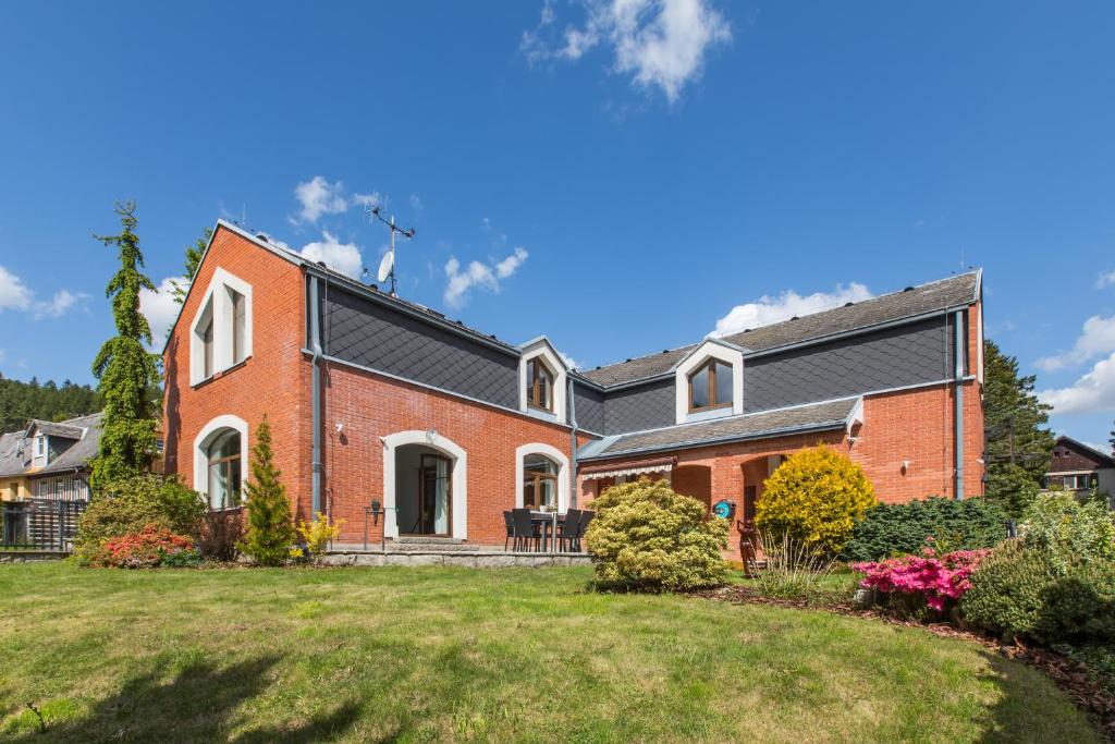 a red brick house with a black roof at Vila Adalbert in Liberec