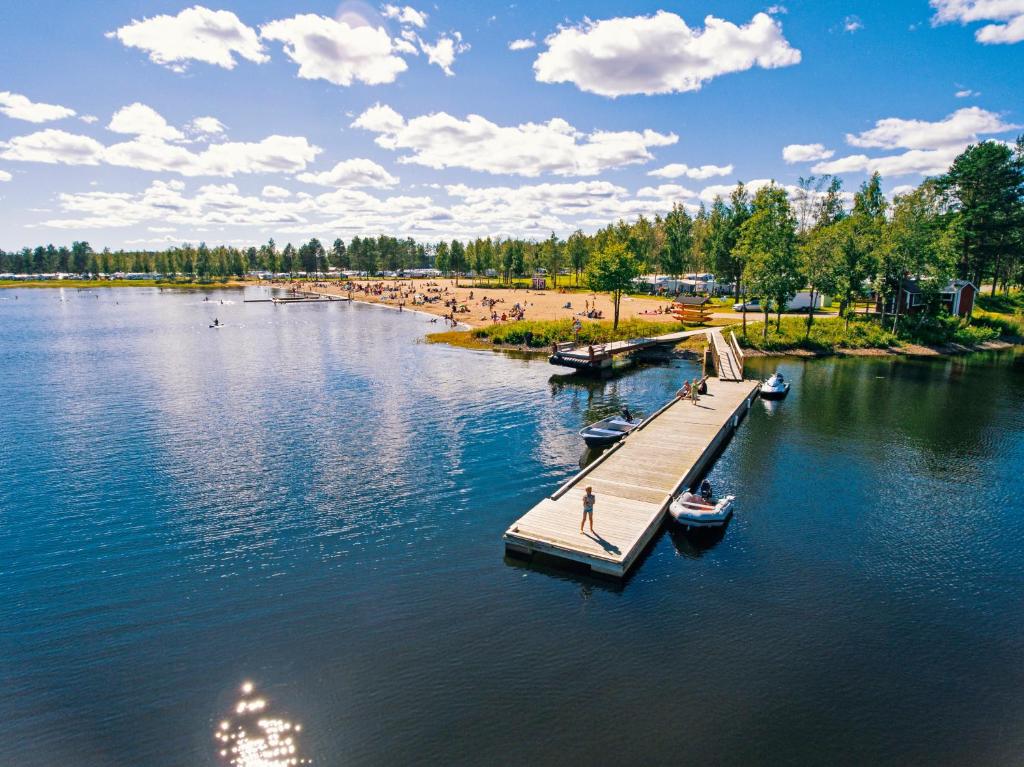 a dock in the middle of a lake with people on it at First Camp Arcus-Luleå in Luleå