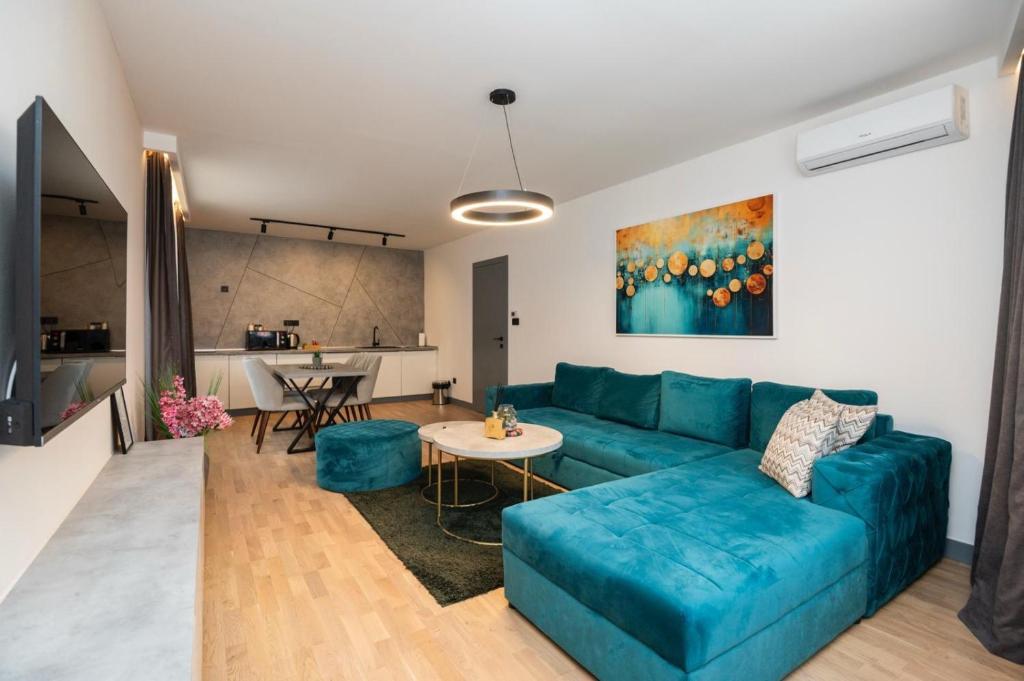 a living room with a blue couch and a table at Crystal Apartments Old Town Sarajevo in Sarajevo