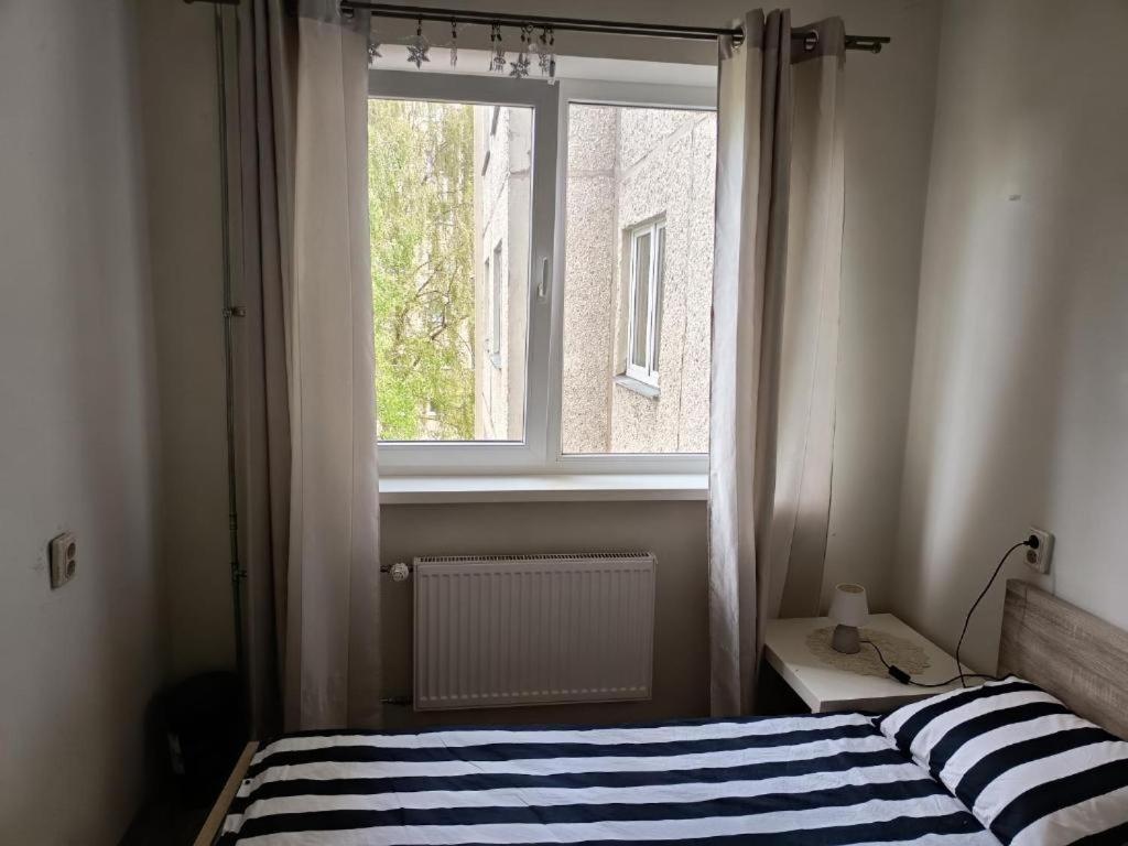 een slaapkamer met een bed en een raam bij 2 in 4 Rooms Apartment in Tallinn