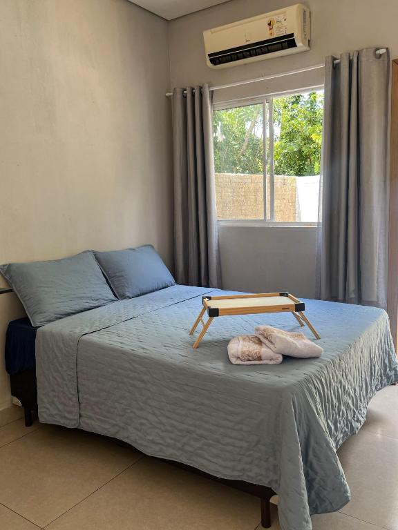 En eller flere senge i et værelse på Fica Aki - Hospedagem Alta Floresta