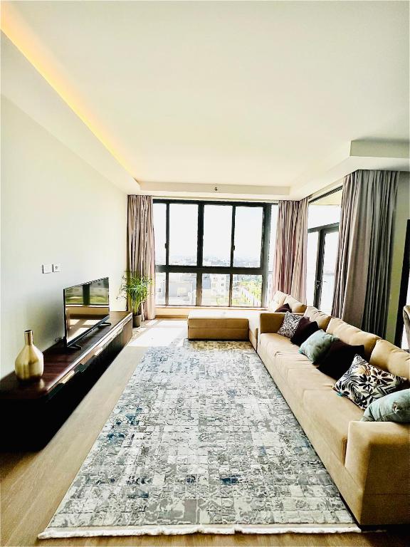 a living room with a couch and a television at Premium hotel apartment Aeon towers Sheikh Zayed City in 6th Of October