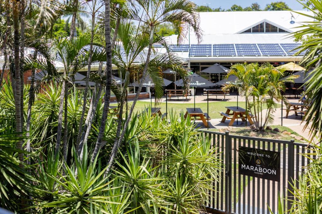 vista su un resort con palme e recinzione di Maraboon Motor Inn a Emerald