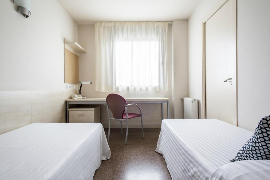 Posteľ alebo postele v izbe v ubytovaní Residencia Universitaria Resa Manuel Agud Querol