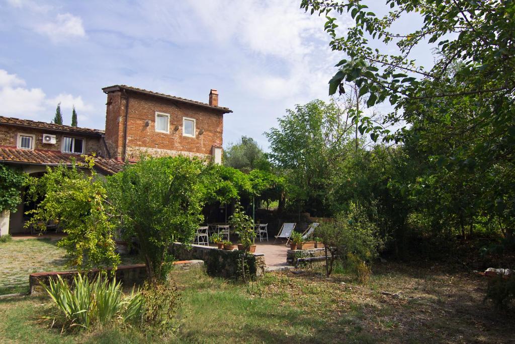 a large brick house with a garden in front of it at Il Monasteraccio in Florence