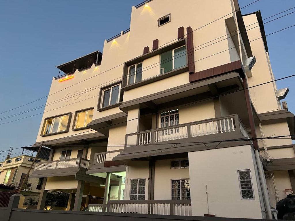 a tall building with balconies on the side of it at Hotel ODC Residency in Jowai