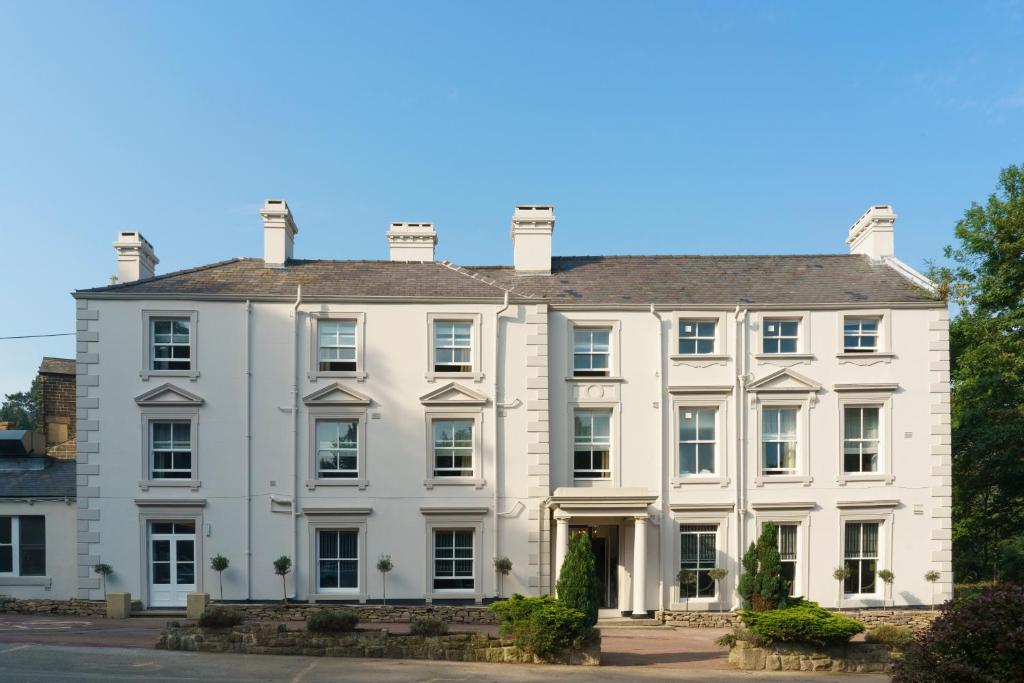 a large white house with a roof at New Bath Hotel & Spa in Matlock