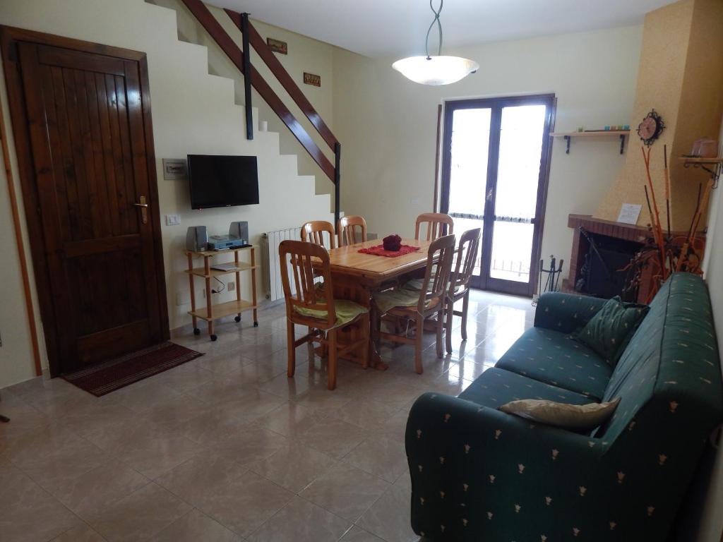 a living room with a couch and a table and chairs at Sangro Apartment in Castel di Sangro