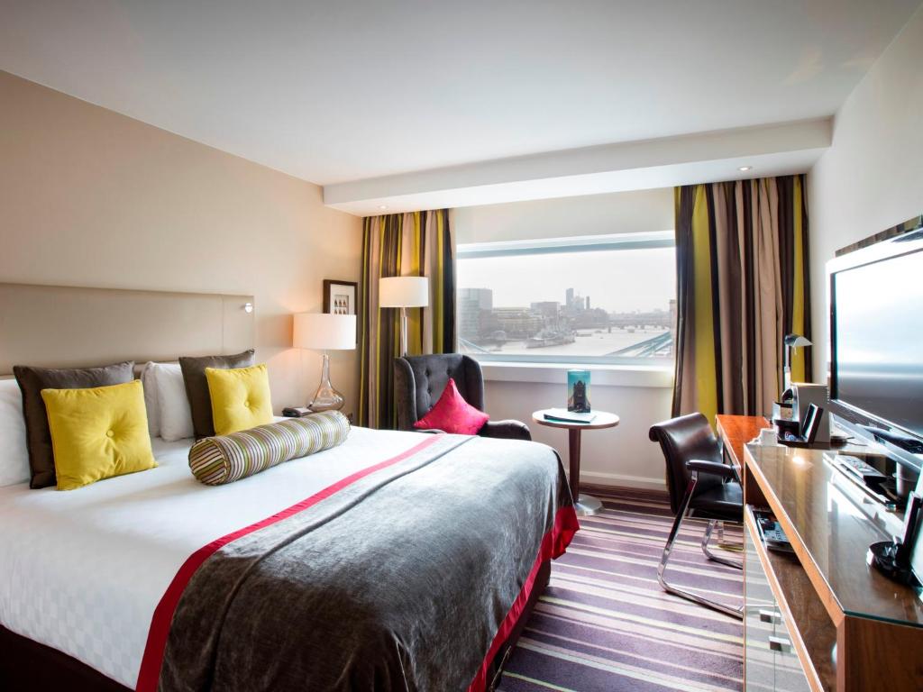a hotel room with a bed and a television at The Tower Hotel, by Thistle in London