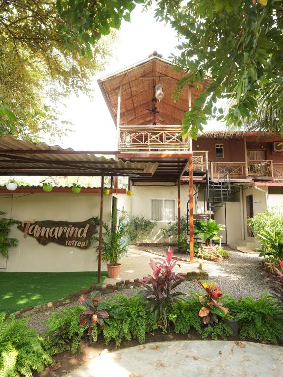 a building with a sign on the side of it at Tamarind Retreat in Alibaug