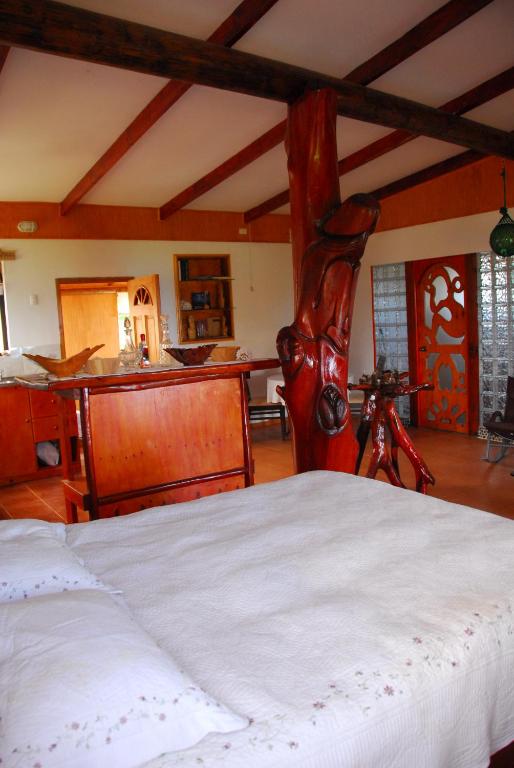 a bedroom with a large bed in a room at Cabañas Moai in Hanga Roa