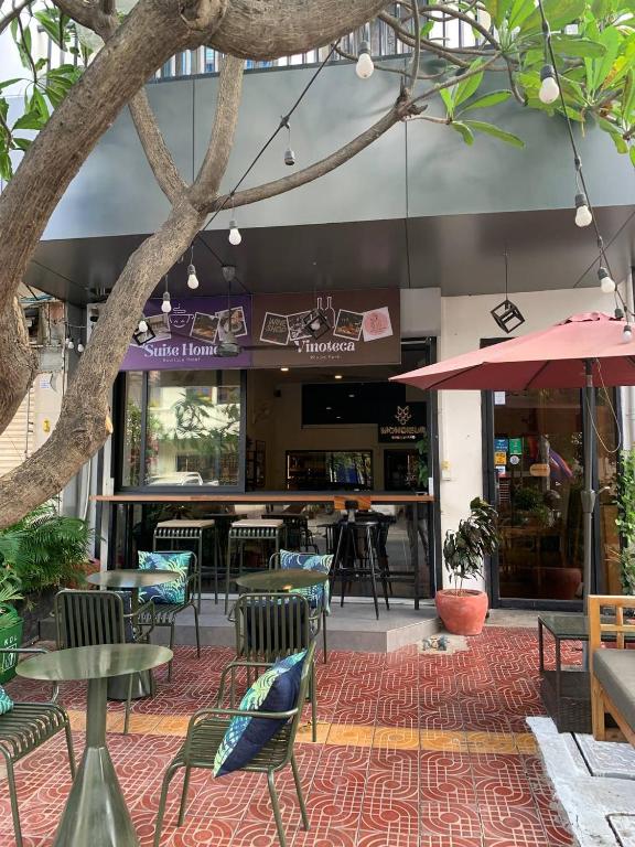 a restaurant with tables and chairs and a bar at Suite Home Boutique Hotel in Phnom Penh