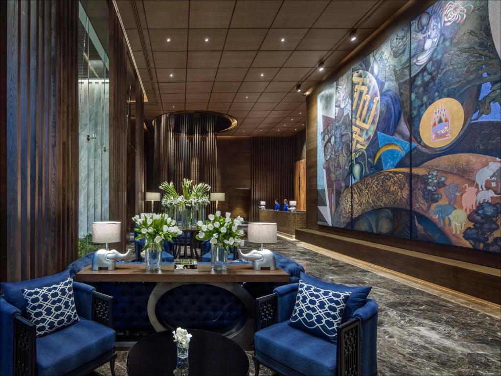 A richly decorated lobby lounge beside a large mural.