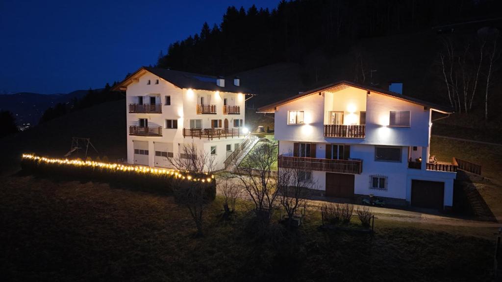 a building with lights in front of it at night at Agriturismo Ferienhof Gschloier - Adults only in Laion