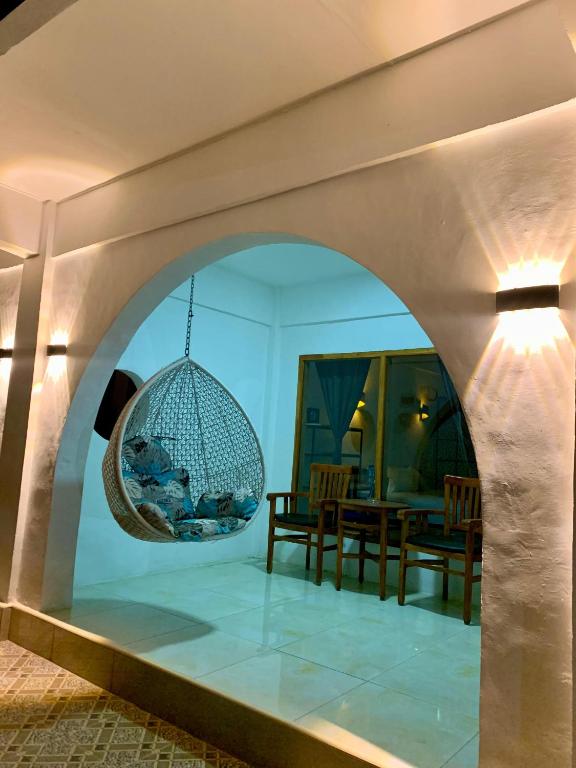 an archway in a living room with a dining table at Bale Hotel & Cowork in Kuta Lombok