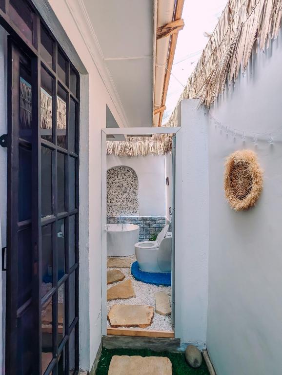 a bathroom with a tub and a toilet in a room at Kali Hideaway Experience Arusha in Arusha