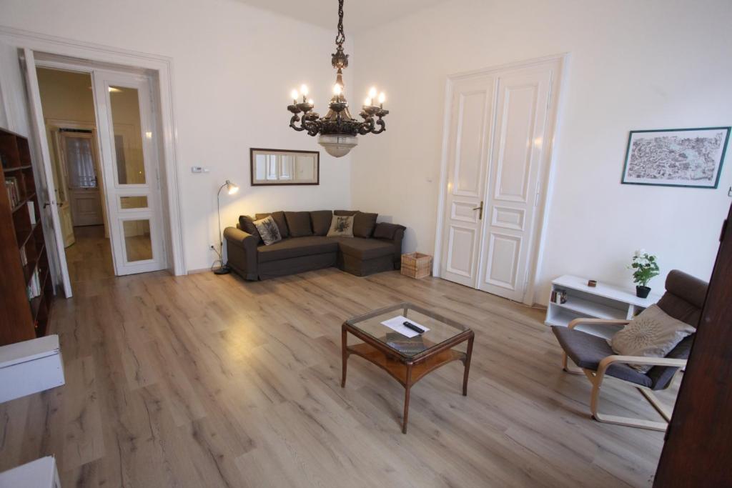 a living room with a couch and a table at Sissy Apartment in Budapest