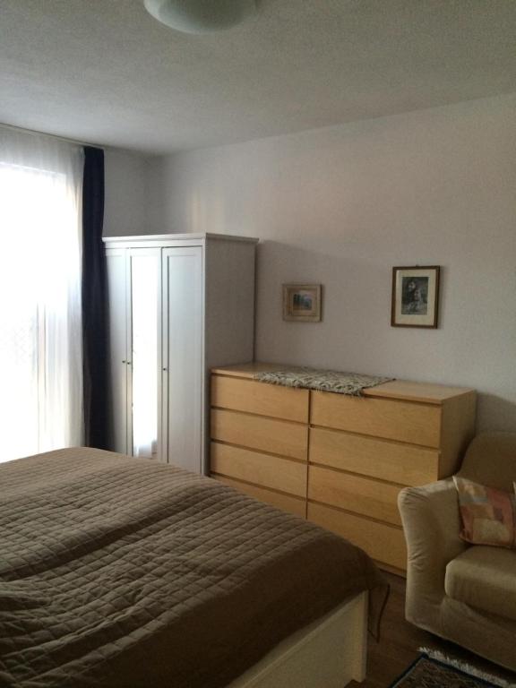 a bedroom with a bed and a dresser and a chair at Apartman Elena in Kežmarok