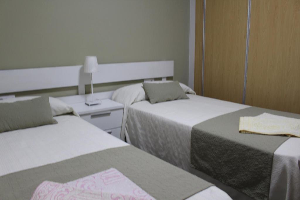 a room with two beds at Apartamentos Bolonia Paraiso in Bolonia