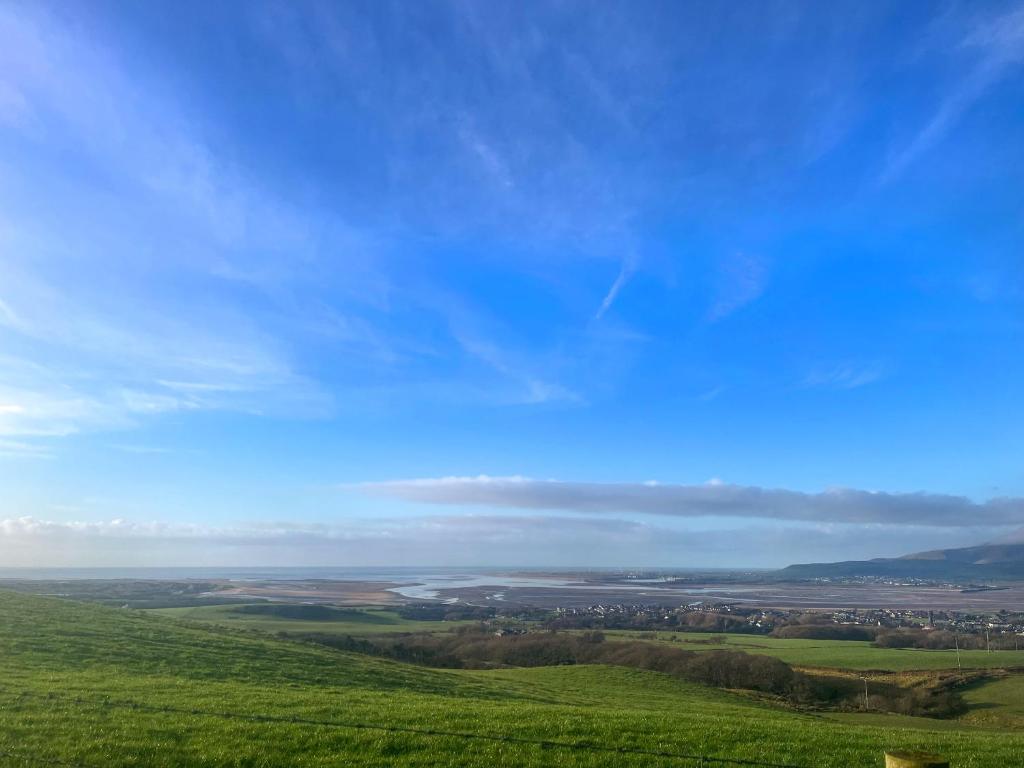 a green field with a blue sky in the background at Birds - Uk48489 in Dalton in Furness
