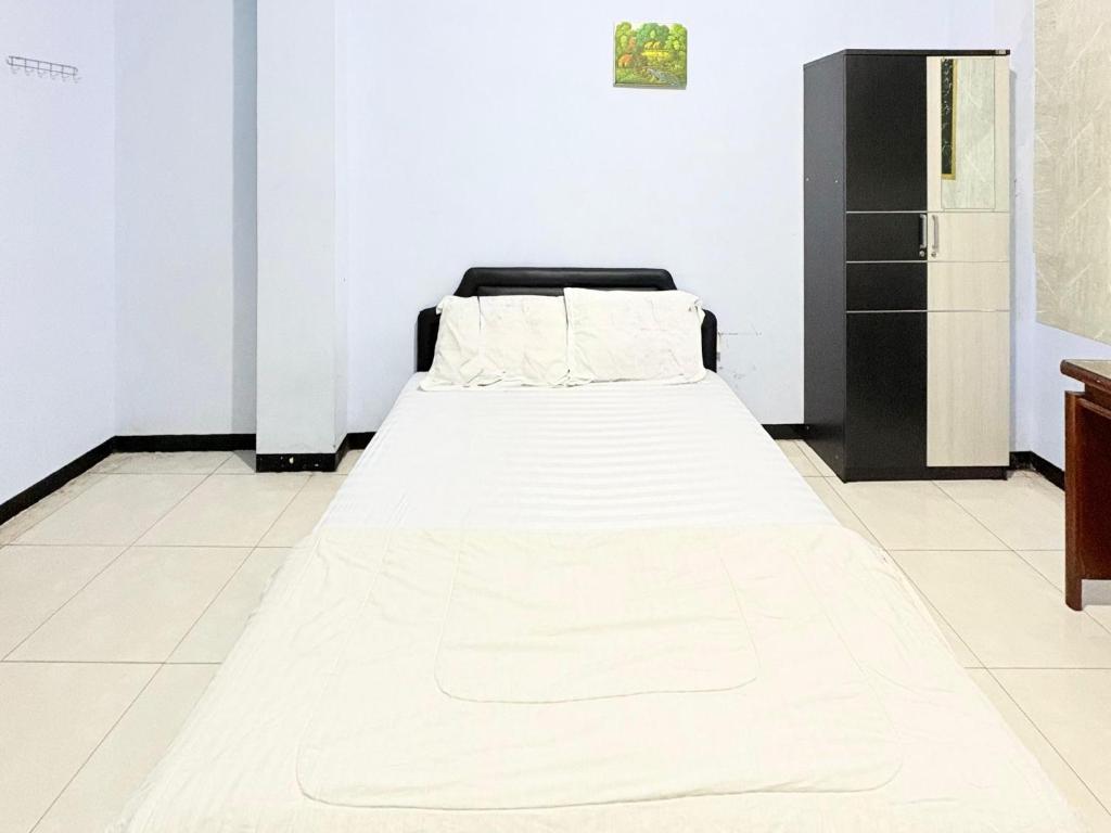 En eller flere senge i et værelse på Trisna Patihan Resort