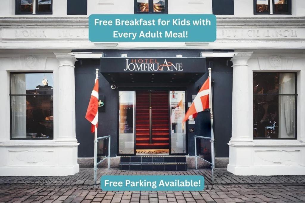 a building with two flags in front of it at Dancenter Hotel Jomfru Ane in Aalborg