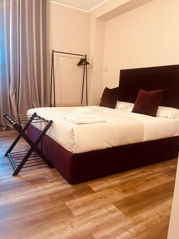a bedroom with a large bed with a black frame at Gatto Bianco Carulli in Bari