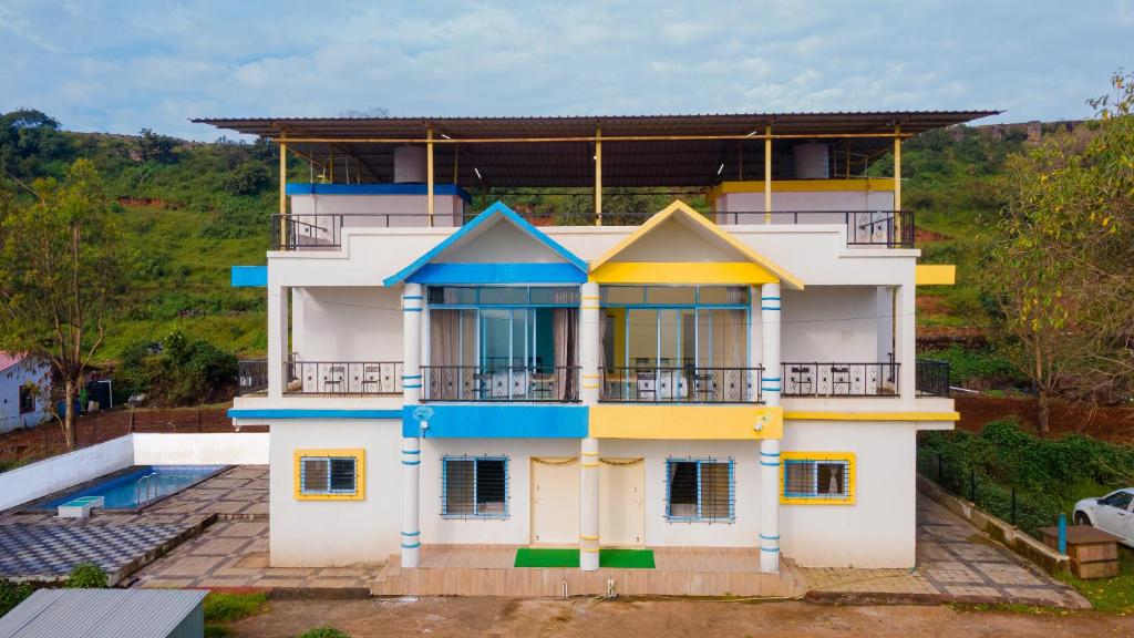 a house with a blue and yellow at Saachi Villa in Panchgani