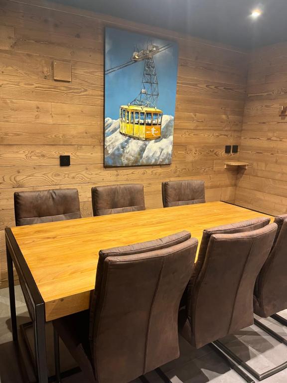 a conference room with a wooden table and chairs at Les Appartements de Maé in Val Thorens