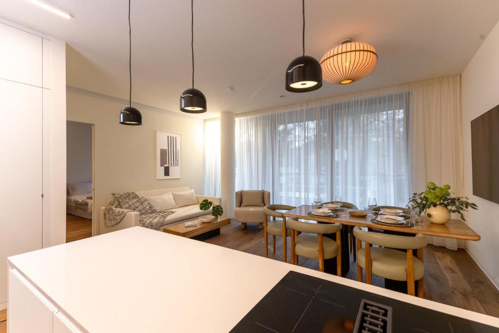 a kitchen and living room with a table and chairs at BLOOM-Living in Linz