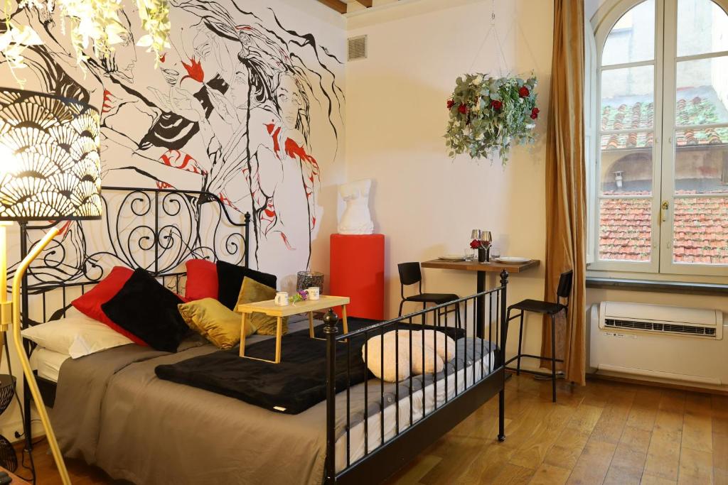 a bedroom with a bed and a large painting on the wall at Lunar artistic loft in Pisa