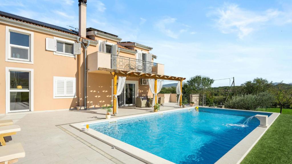 a swimming pool in the backyard of a house at Villa Pleter by Villas Guide in Ružić