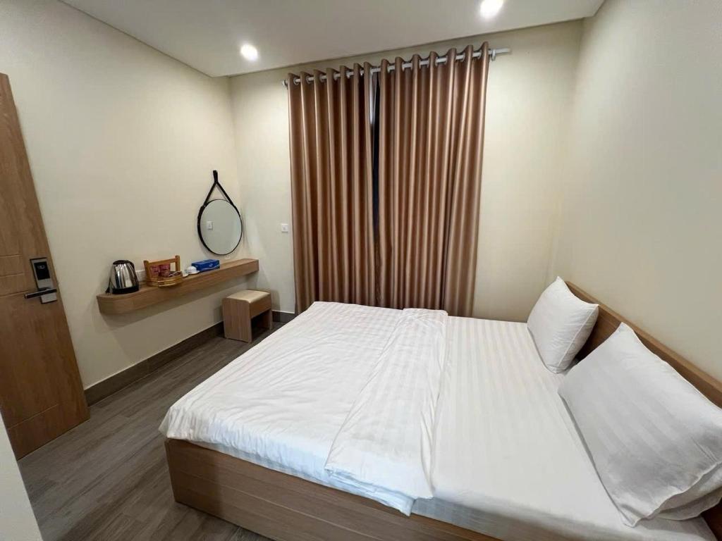 En eller flere senge i et værelse på T Homestay