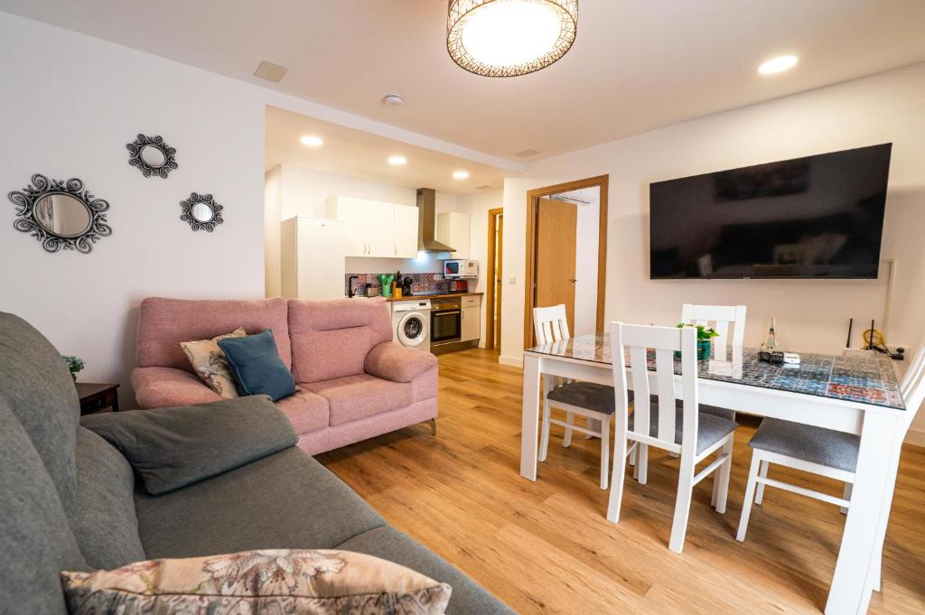 a living room with a couch and a table at YourHouse Apartamentos Andasol 1D in Chipiona
