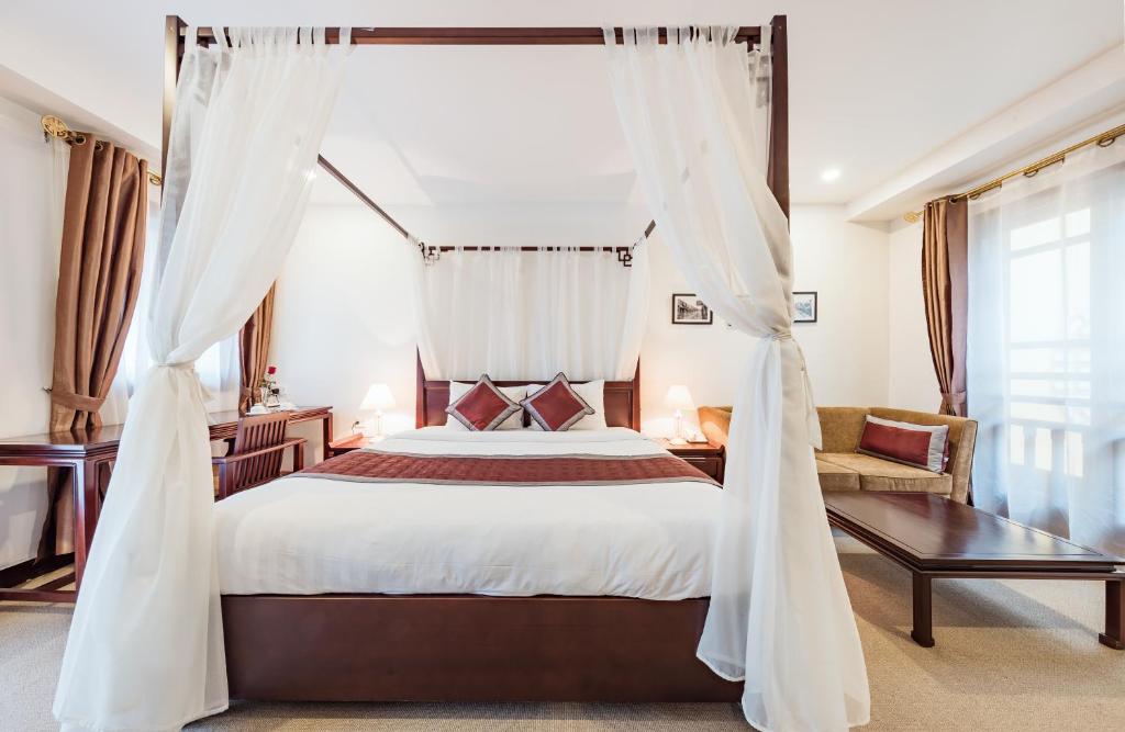 Ein Bett oder Betten in einem Zimmer der Unterkunft La Dolce Vita Hotel
