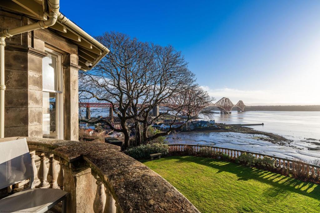 a house with a view of a river and a bridge at Cleish Apartment in Edinburgh