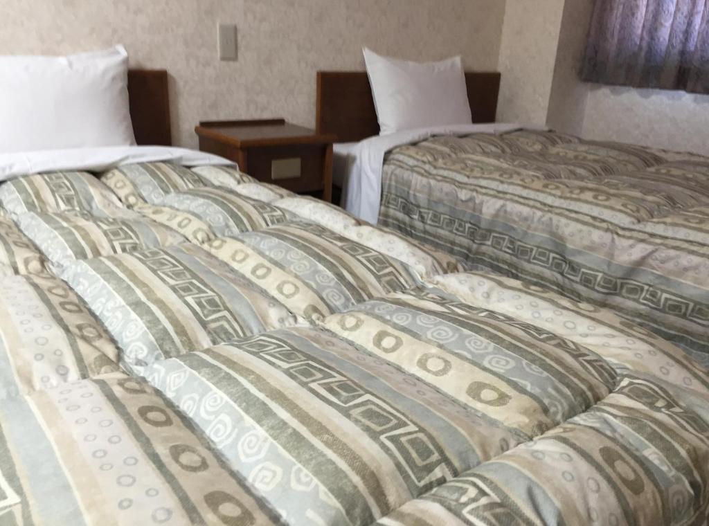 Postel nebo postele na pokoji v ubytování Shinseto Station Hotel
