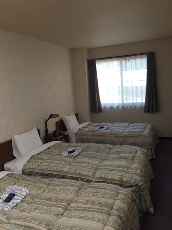 Postel nebo postele na pokoji v ubytování Shinseto Station Hotel