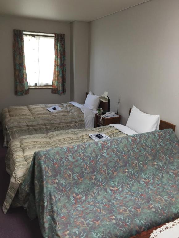 Postel nebo postele na pokoji v ubytování Shinseto Station Hotel