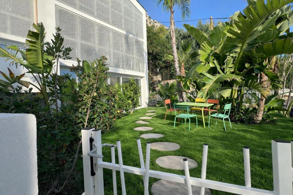 a garden with a table and chairs on the grass at Pop villa in La Celle-sous-Gouzon