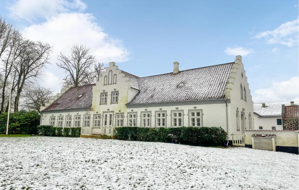 a large white house with a large yard at Pet Friendly Home In Haarby With Sauna in Brydegård