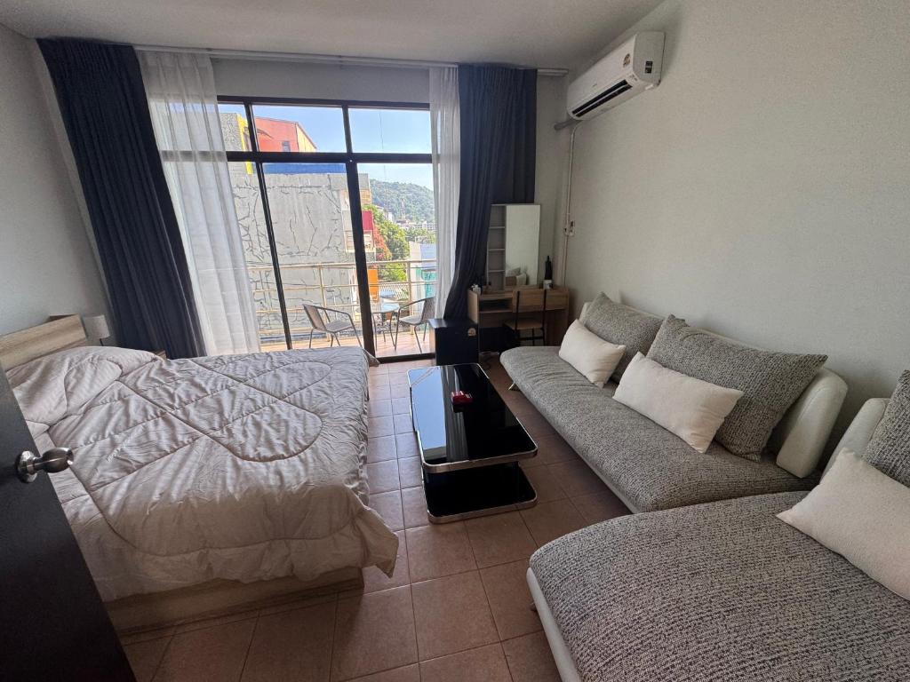 a living room with a bed and a couch at KataKeet in Kata Beach