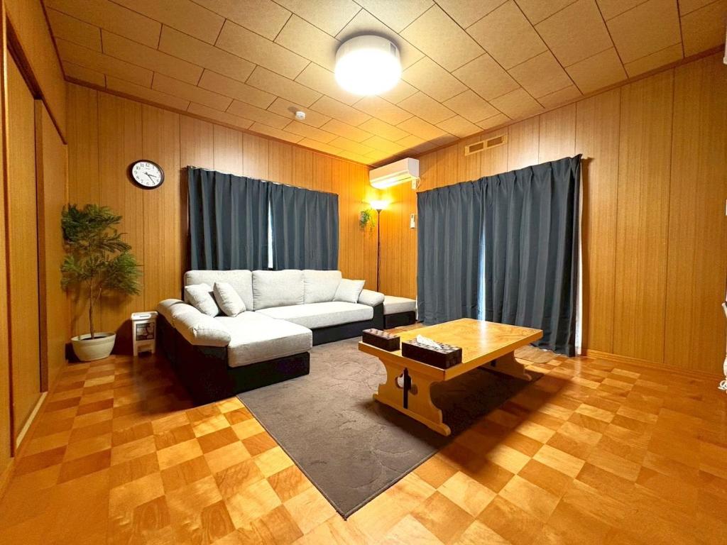 a living room with a couch and a coffee table at Nikko Central GOKO STAY in Nikko