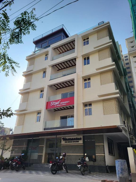 two motorcycles parked in front of a building at Stae Residency Hitec City in Hyderabad