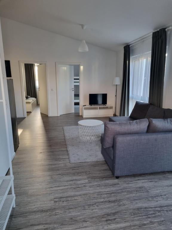 a living room with a couch and a tv at Ferienwohnung Euchen 2 in Würselen