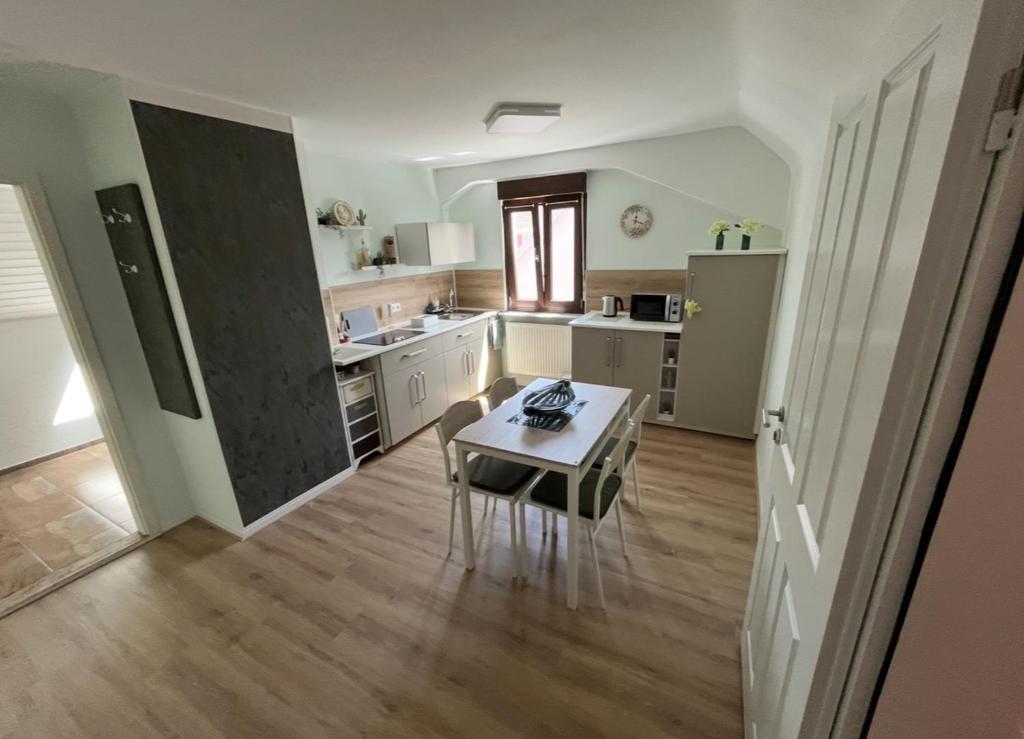 a large kitchen with a table and a table at La mansardina in Lörrach
